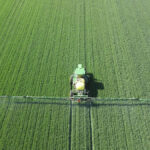Photo of John Deere sprayer in green field